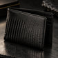Black textured leather wallet with a crocodile or alligator skin pattern, shown closed against a plain off-white background.