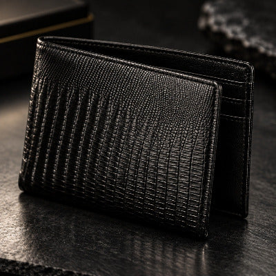 Black textured leather wallet with a crocodile or alligator skin pattern, shown closed against a plain off-white background.