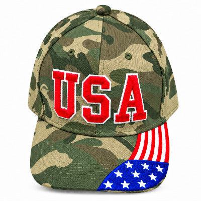 A camouflage baseball cap featuring large red embroidered 'USA' lettering on the front and an American flag design on the brim, shown against a plain light gray background.