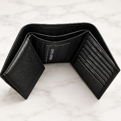 A black leather wallet shown open on a white surface, displaying its interior compartments, card slots, and a paper ID holder with a visible orange price sticker.