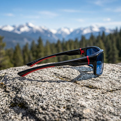Black sports sunglasses with dark lenses and red accent details on the temples, shown on a plain light background.